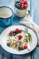 Sweet dumplings with berry fruits and cream
