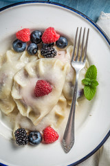 Homemade dumplings with blueberry, blackberry and raspberry