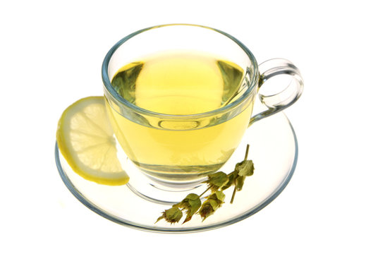 Herbal tea, sage leaves and lemon slice isolated on white background
