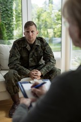 Therapist diagnosing soldier