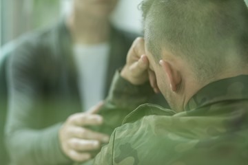 Fototapeta premium Therapist supporting her military patient