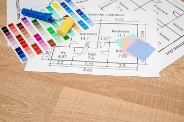 architectural plan of the house, color palette, furniture and fabric samples on wooden table
