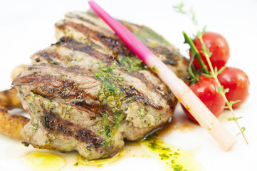 Grilled steak with sauce and greens on white background