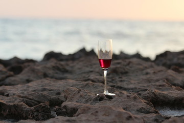 A glass of wine on the beach.
