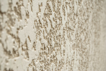 Decorative plaster wall with yellow structure as texture