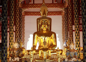 Golden seated buddhas in front of decorative  in suandok temple