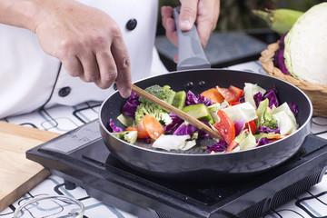 Chef cooking stir fried vegetable