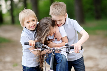 three children playing on meadow in summer