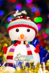 Close-up festive snowman with Christmas blurred lights background