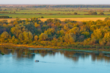 fishermen sit in the boat on the river