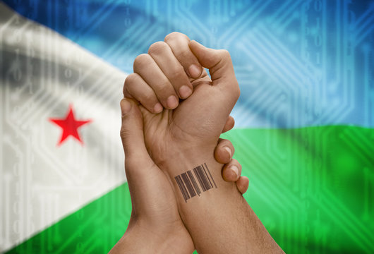 Barcode ID number on wrist of dark skinned person and national flag on background - Djibouti