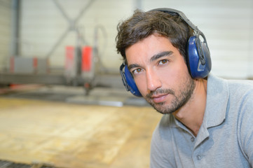 young man with earmuffs - obrazy, fototapety, plakaty