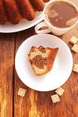 Marble cake and coffee cup on wooden table 