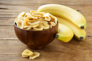 banana chips, dried fruit on a wooden table © Olga Kriger