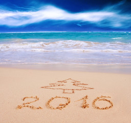 New Year 2016 written on sandy beach.