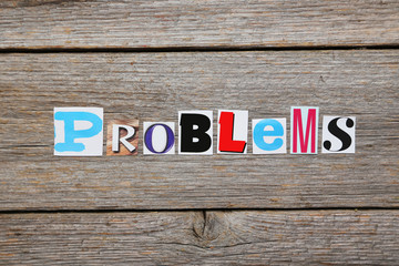 The word Problems in cut out magazine letters