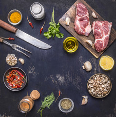 ingredients for cooking pork steak seasoning, oils, knife and fork place for text,frame on wooden rustic background top view