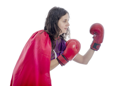 Woman superhero with red cape and red gloves boxing.