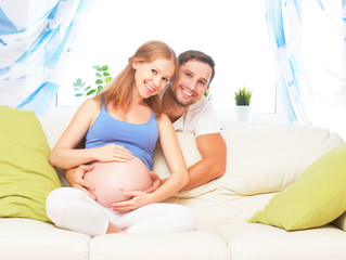 happy family in anticipation of birth of baby. Pregnant woman an