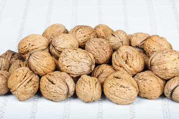 Macro of walnuts on white tablecloth