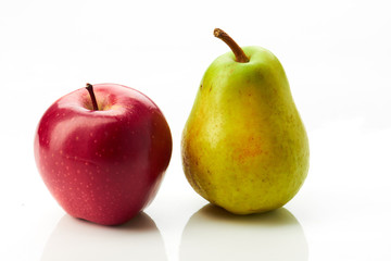 Pear and red apple on white