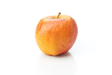 Old apple on white