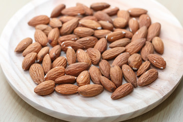 Some almonds in a wooden bowl closeup