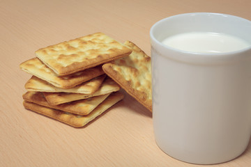 Selective focus craker ,milk on wood background.