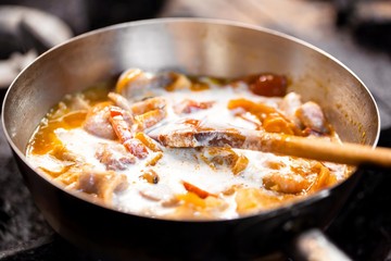 cooking meat in a frying pan