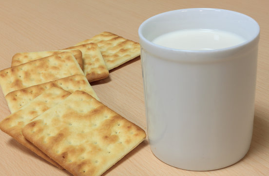 Selective focus milk and blur craker on wood background.