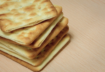 Cracker stack together on wooden background.