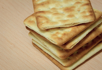 Cracker stack together on wooden background.