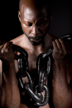 Black Man Holding Heavy Chain