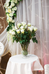 Artificial white roses in a vase.