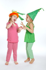 Two little girls with vegetation costumes