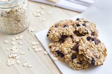 Homemade healthy oatmeal cookies on a wooden kitchen table.