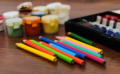 Table of the artist with paints, brushes, pencils