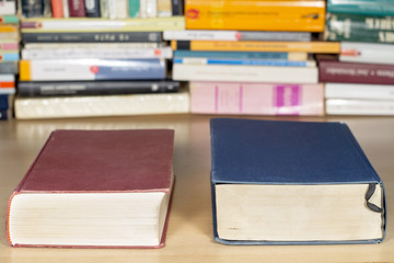 Red and blue books on a clear wooden desk