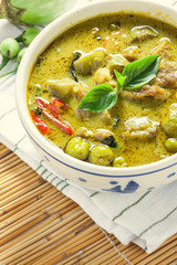 Thai food the pork green curry and eggplant on bamboo background