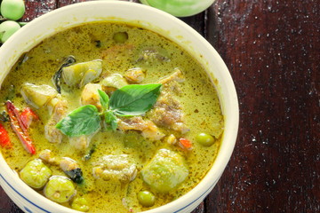 Thai food the pork green curry and eggplant on wood background.