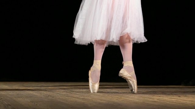 Ballerinas dancing classic ballet pas. Close up of legs of dancers of Ballet. Classical dancing. Real time full hd video of dancing young girls.