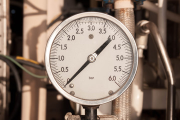 pressure gauge with blue stucture background.