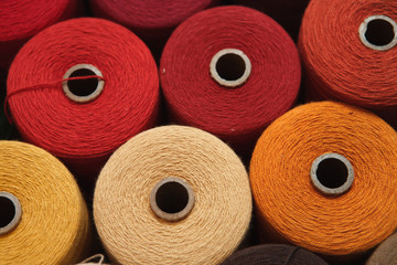 Color sewing threads as a background close up