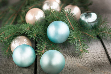 Fototapeta na wymiar Christmas balls on wooden background with branches of spruce. Decoration.