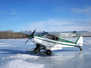 Ice fishing, airplanes on frozen lake
