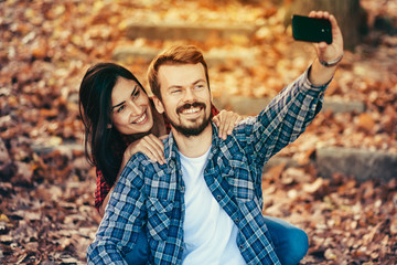 Taking a selfie/A happy couple having fun and taking a selfie