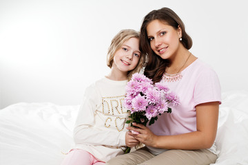 Happy family. Mother and daughter with flowers