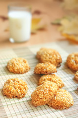 Milk and homemade crispy cereal cookies with seasonal decoration fall leaves.