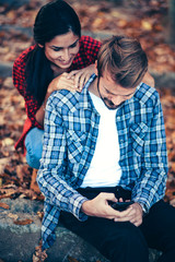 Fototapeta premium Fun/Couple have fun using smartphone outdoor