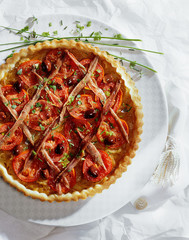 Onion pie with anchovy and tomatoes.